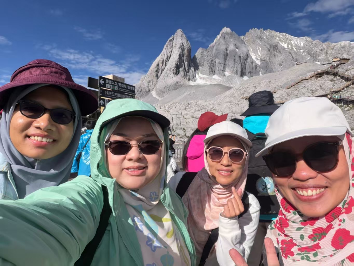 Travelers smiling at Jade Dragon Snow Mountain in Yunnan