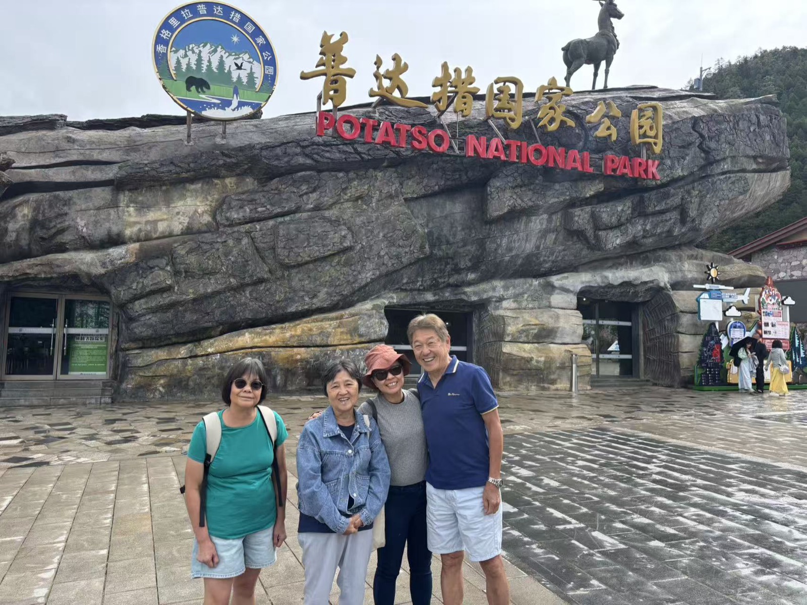 Four older travelers standing at the Pudacuo National Park entrance